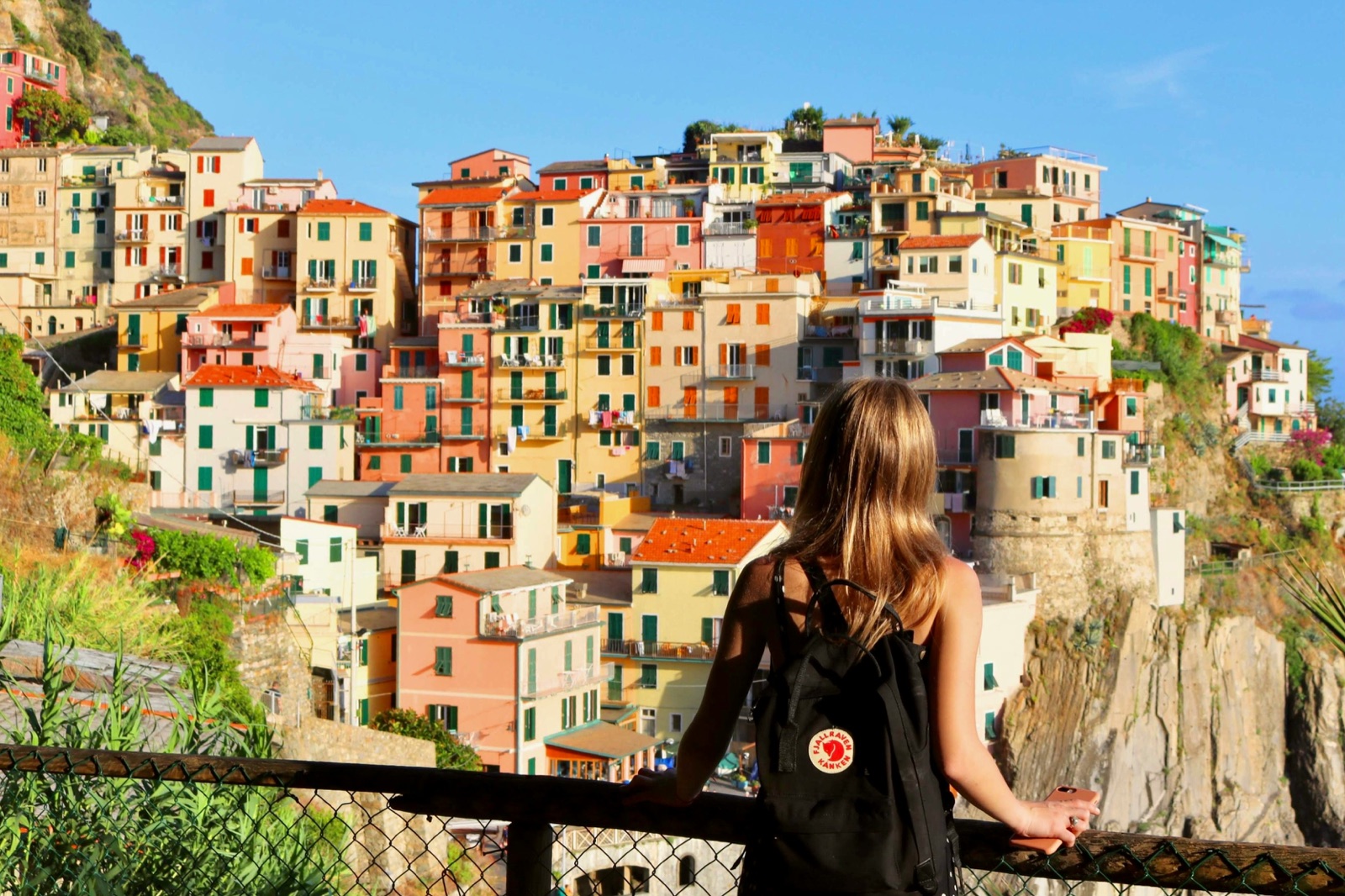 Traveler overlooking a colorful Italian village